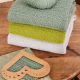 gestrickte Pullover gestapelt, davor liegend ein Nadelmesser aus Holz